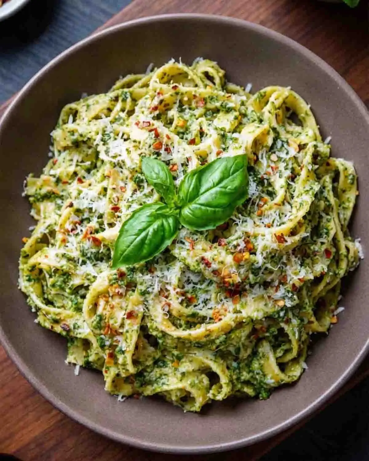 Creamy Pesto Pasta: A Harmony of Freshness and Indulgence 4 Creamy pesto pasta with parmesan cheese and fresh basil garnish served in a bowl
