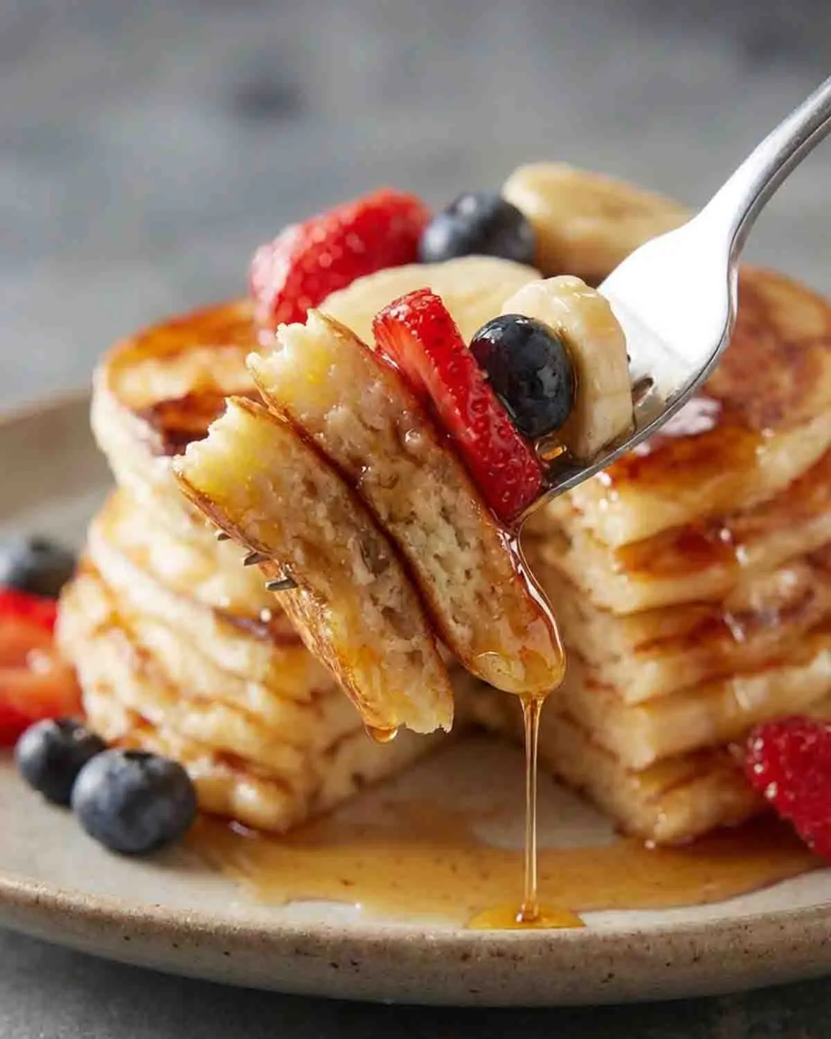 Fluffy Pancakes Delight: A Heavenly Breakfast Treat! 3 Fluffy pancakes topped with blueberries and syrup close-up breakfast scene
