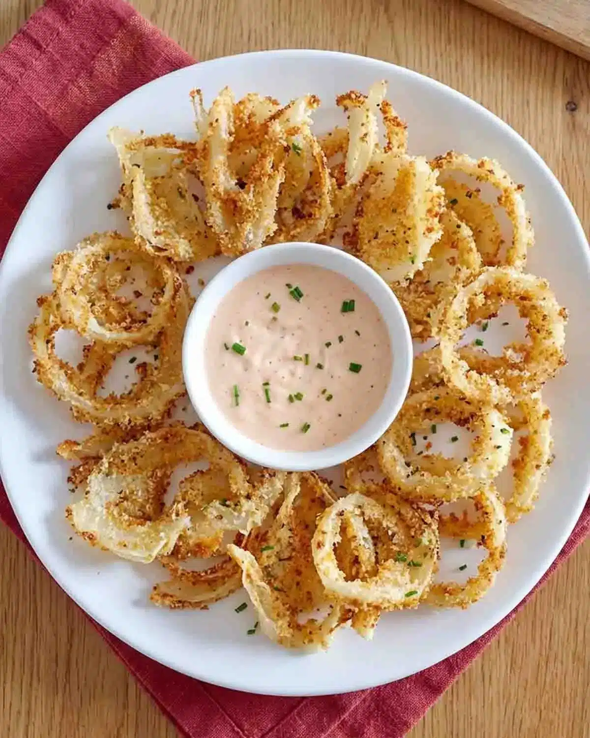Air-Fryer Crispy Onion Petals 3 Air-Fryer Crispy Onion Petals served on a plate with a creamy dipping sauce, golden and crunchy with a perfectly seasoned coating.