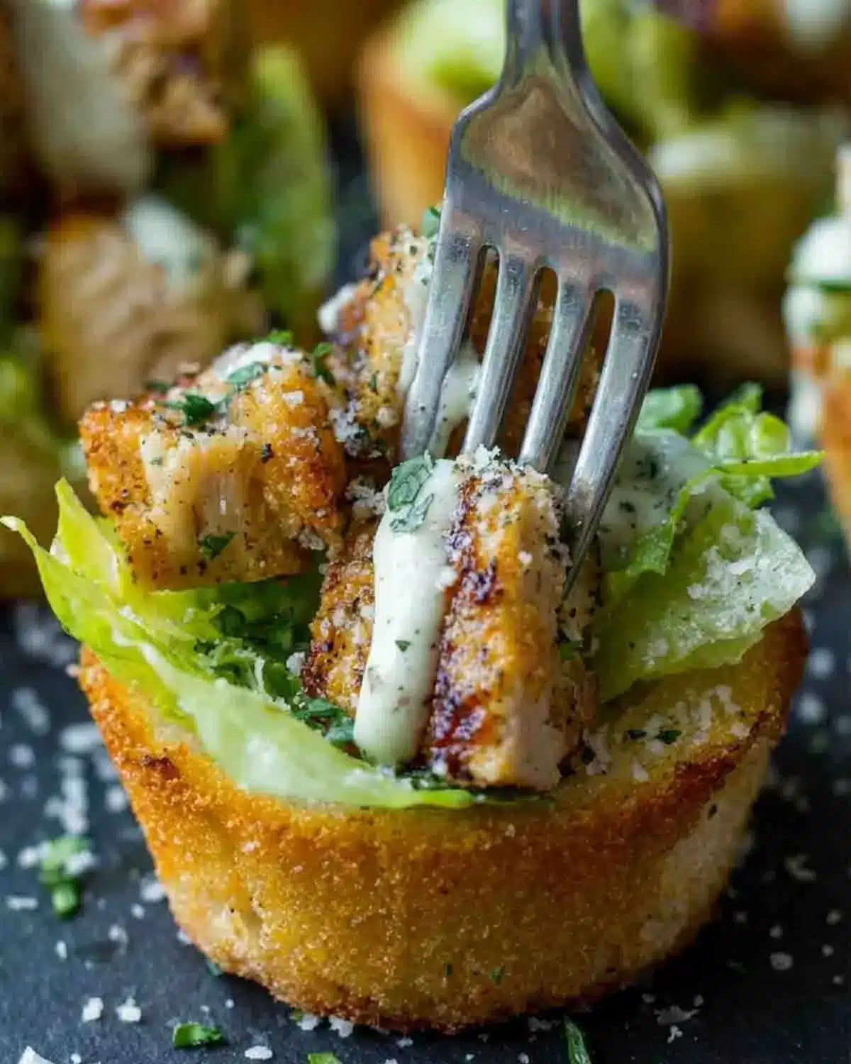 Chicken Caesar Crouton Cups 4 Close-up of Chicken Caesar Crouton Cups with crispy bread, grilled chicken, romaine lettuce, Parmesan, and creamy Caesar dressing