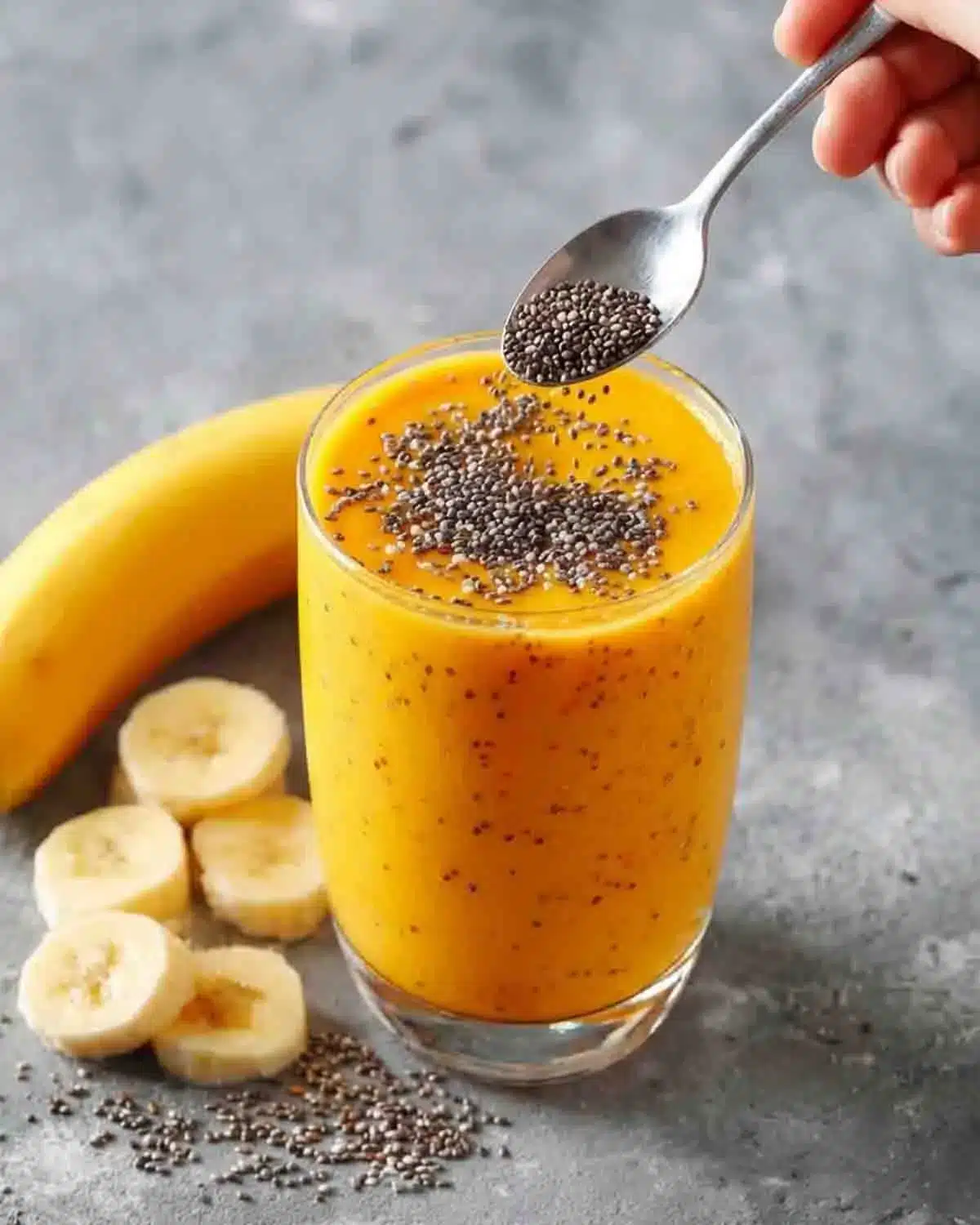 Tropical Chia Smoothie 4 Tropical chia smoothie topped with chia seeds, made with mango and banana in a glass for a healthy breakfast drink
