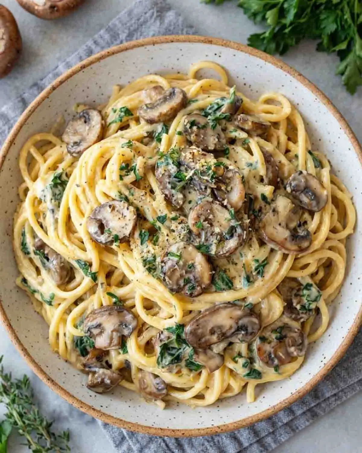 Creamy Garlic Mushroom Pasta 3 Creamy garlic mushroom pasta served in a bowl with fettuccine, sautéed mushrooms, Parmesan cream sauce, and fresh herbs on top